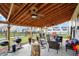 Spacious covered patio with comfortable seating, ceiling fans, and outdoor cooking area, perfect for entertaining and relaxation at 2282 Creekland Dr, Columbus, IN 47201