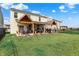 Backyard featuring a spacious lawn with covered patios providing an ideal outdoor living and entertainment space at 2282 Creekland Dr, Columbus, IN 47201