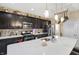 This spacious kitchen features dark wood cabinets, stainless steel appliances, and a large island with seating at 2282 Creekland Dr, Columbus, IN 47201