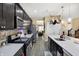 This spacious kitchen features dark wood cabinets, stainless steel appliances, and a large island with seating at 2282 Creekland Dr, Columbus, IN 47201