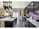 A spacious kitchen offers dark wood cabinets, stainless steel appliances, and a large center island at 2282 Creekland Dr, Columbus, IN 47201
