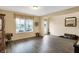 Bright living room featuring laminate flooring, a large window, and a stylish entry door with decorative glass at 2282 Creekland Dr, Columbus, IN 47201