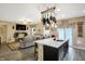 Open concept living space showing the kitchen island, dining table, and living room furniture at 2282 Creekland Dr, Columbus, IN 47201