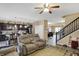 Living room featuring a view of kitchen, stairs, and wood laminate flooring at 2282 Creekland Dr, Columbus, IN 47201