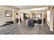 Spacious open-concept living area with modern gray laminate flooring, neutral walls, and ample natural light from large windows at 2282 Creekland Dr, Columbus, IN 47201