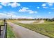 Scenic view of a paved walking path, pond, and neighborhood, offering an active lifestyle within the community at 2282 Creekland Dr, Columbus, IN 47201