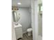 Bathroom with modern vanity, a commode, and a luxurious tile shower at 2813 Collier St, Indianapolis, IN 46241