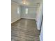 This bedroom offers abundant natural light and stylish, gray flooring at 2813 Collier St, Indianapolis, IN 46241