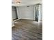 Bright bedroom features wood-look flooring and large closet space at 2813 Collier St, Indianapolis, IN 46241