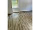 Light-filled bedroom features wood-look floors and neutral paint at 2813 Collier St, Indianapolis, IN 46241