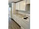 This kitchen features white cabinets, laminate countertops, and modern appliances at 2813 Collier St, Indianapolis, IN 46241