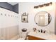 Charming bathroom features stylish fixtures, a vanity, a round mirror, and modern decor at 3147 Bonham Dr, Indianapolis, IN 46222