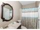 Nicely appointed bathroom with decorative mirror, vanity, and a shower with curtain at 3147 Bonham Dr, Indianapolis, IN 46222