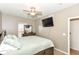 Cozy bedroom features a ceiling fan, a TV, neutral carpet, a window and closet at 3147 Bonham Dr, Indianapolis, IN 46222