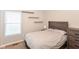 Bedroom with a large bed, dresser, floating shelves and a window with blinds at 3147 Bonham Dr, Indianapolis, IN 46222