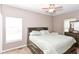 Cozy bedroom features a queen bed, neutral carpet, a ceiling fan and a window at 3147 Bonham Dr, Indianapolis, IN 46222