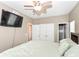 Comfortable bedroom with a Roku TV, ceiling fan, carpet flooring, neutral paint, and closets at 3147 Bonham Dr, Indianapolis, IN 46222