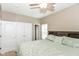 Comfortable bedroom with a ceiling fan, carpet flooring, neutral paint, and attached closets at 3147 Bonham Dr, Indianapolis, IN 46222