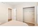 Bedroom featuring a closet with shelving and an entry door, and neutral carpeting at 3147 Bonham Dr, Indianapolis, IN 46222