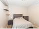 Neutral bedroom featuring floating shelves and matching bedside tables and a gray headboard at 3147 Bonham Dr, Indianapolis, IN 46222