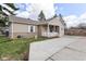 This lovely home features a quaint porch, enhanced by a long driveway and lush green lawn at 3147 Bonham Dr, Indianapolis, IN 46222