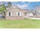 Charming home featuring a well-maintained lawn, complemented by white-framed windows and tan siding at 3147 Bonham Dr, Indianapolis, IN 46222