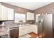 Well-lit kitchen features stainless steel appliances, white cabinetry, and laminate countertops at 3147 Bonham Dr, Indianapolis, IN 46222
