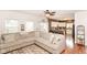 Open-concept living room with hardwood floors flowing into a well-lit kitchen and outdoor patio access at 3147 Bonham Dr, Indianapolis, IN 46222