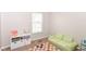 Bright playroom with a large window, soft green sofa, and colorful rug at 3147 Bonham Dr, Indianapolis, IN 46222