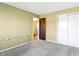 Bedroom featuring light green walls, neutral carpet, and access to another room at 321 Pleasantview Dr, Greenwood, IN 46142