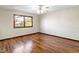 This bedroom has hardwood floors, a ceiling fan, and a window at 321 Pleasantview Dr, Greenwood, IN 46142