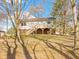 View of this home showcasing the walk-out basement, backyard deck, mature trees and stairs at 321 Pleasantview Dr, Greenwood, IN 46142