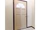 The front door has a half-moon window and dark trim at 321 Pleasantview Dr, Greenwood, IN 46142