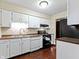 This kitchen has white cabinets, modern appliances, and a view of the sink at 321 Pleasantview Dr, Greenwood, IN 46142