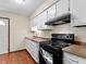 Kitchen with white cabinets, black appliances, and wood-look flooring, featuring a range at 321 Pleasantview Dr, Greenwood, IN 46142