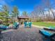 Beautiful backyard patio with outdoor seating, dining area, a built-in grill, and a well-manicured lawn at 3610 Eagle Emblem Ct, Greenwood, IN 46143