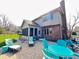 Spacious backyard patio featuring outdoor furniture, a screened in porch, lush landscaping, and brick home exterior at 3610 Eagle Emblem Ct, Greenwood, IN 46143
