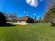 Spacious backyard with basketball court, well-maintained lawn, and a partial view of the house at 3610 Eagle Emblem Ct, Greenwood, IN 46143
