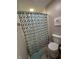 Bathroom view showcasing shower with a colorful patterned curtain and a toilet at 3610 Eagle Emblem Ct, Greenwood, IN 46143