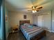 Bedroom featuring a cozy bed, a ceiling fan, and a view of a sliding barn door at 3610 Eagle Emblem Ct, Greenwood, IN 46143