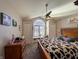 Bedroom with vaulted ceiling, featuring an arched window with a charming window seat and a cozy cowhide blanket at 3610 Eagle Emblem Ct, Greenwood, IN 46143