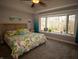Bright bedroom featuring a large bay window with natural light and a queen bed at 3610 Eagle Emblem Ct, Greenwood, IN 46143
