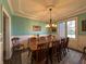 Elegant dining room with wainscoting, large table, and traditional chandelier at 3610 Eagle Emblem Ct, Greenwood, IN 46143