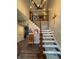 Grand foyer featuring a wooden staircase, chandelier, and decoratively adorned walls at 3610 Eagle Emblem Ct, Greenwood, IN 46143