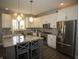 Well-lit kitchen featuring an island with seating, stainless steel appliances, and white cabinetry at 3610 Eagle Emblem Ct, Greenwood, IN 46143