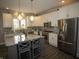 Bright kitchen featuring white cabinets, stainless steel appliances, and a granite-topped island with seating at 3610 Eagle Emblem Ct, Greenwood, IN 46143