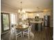 Eat-in kitchen with stainless appliances, white cabinetry, granite counters, and a dining area near a sliding door at 3610 Eagle Emblem Ct, Greenwood, IN 46143