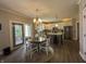 Open-concept eat-in kitchen featuring an island with seating and a dining area with sliding door access at 3610 Eagle Emblem Ct, Greenwood, IN 46143