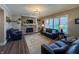 Spacious living room features a stone fireplace and wall of windows overlooking the backyard at 3610 Eagle Emblem Ct, Greenwood, IN 46143
