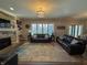 Cozy living room with a stone fireplace and multiple couches for seating at 3610 Eagle Emblem Ct, Greenwood, IN 46143